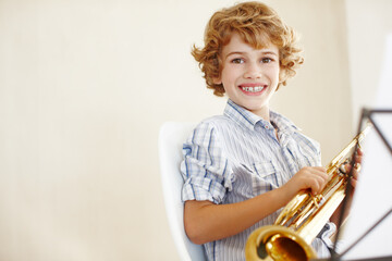 Happy, music and portrait of child with trumpet for learning, lesson and practice for talent show....