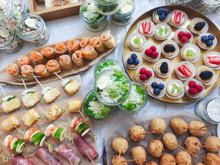 Catering buffet for events. Catering banquet table with different food snacks and appetizers with sandwich, salads, fresh fruits. 
