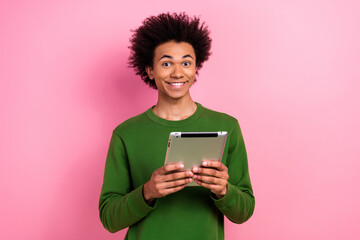 Photo of happy positive guy hold tablet using device isolated pastel color background