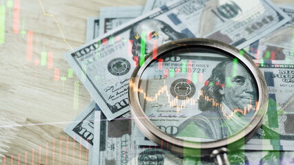 magnifier glass to focus Benjamin Franklin face on USD dollar banknote with stock market chart for analysis investment on currency exchange or forex and economy inflation concept.