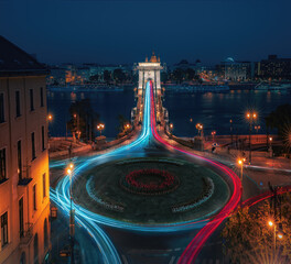 Aerial view of traffic at Clark Adam Square roundabout with Szechenyi Chain Bridge and Danube river at night - Budapest, Hungary