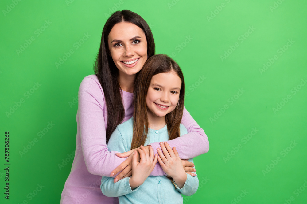 Poster Photo of two people mother daughter smile cuddle empty space ad isolated on bright green color background