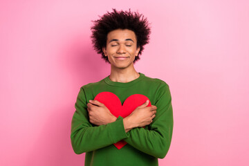 Photo of happy positive guy hold hug heart present for 14 february holiday isolated pastel color...