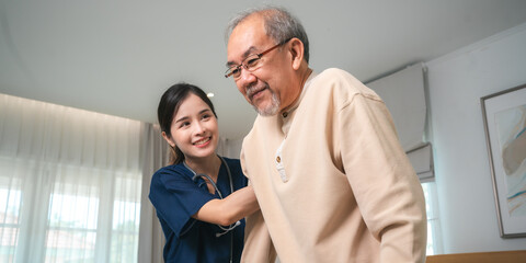 Asian physiotherapist nursing home to support old senior man patient therapy by walker, caregiver nurse help recovery health care with elderly retirement man person at home, health insurance concept