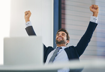 Businessman, winner and success fist in office for celebration, promotion and achievement of goal. Male person or salesman and deal or target with smile, hands up and computer with good news
