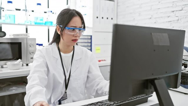 Nervous young chinese woman scientist skeptically frowning in the lab, uneasy and upset over a problem, showing negative emotions