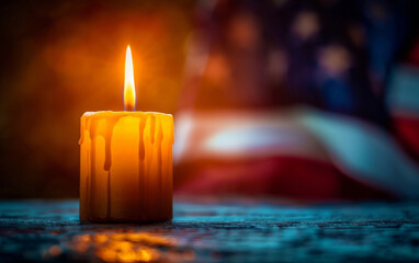 A glowing candle drips wax, with a soft-focus American flag in the backdrop, evoking a mood of remembrance and patriotism.