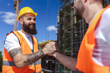Contractor. construction worker team hands shaking after plan project contract  at construction...