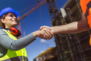Contractor. construction worker team hands shaking after plan project contract  at construction site, contractor, engineering, partnership, construction concept - 787319042