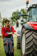 A male worker ready to repair a tractor