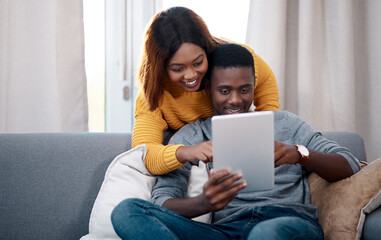 Love, tablet and black couple hug on sofa with social media, streaming or sign up service choice at...