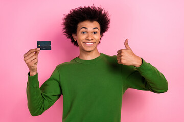 Photo of happy positive guy hold credit card make thumb up symbol isolated pastel color background - obrazy, fototapety, plakaty