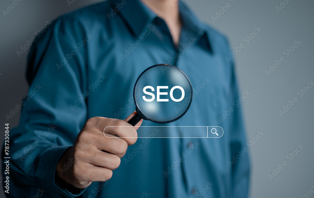 Poster businessman using magnifying glass focus to seo icon to analyze seo search engine optimization for p