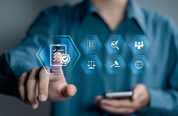 Compliance in business concept. Stay in line with business policies. Businessman touching compliance icon on virtual screen, ensuring the enforcement of laws, regulations, and standards.