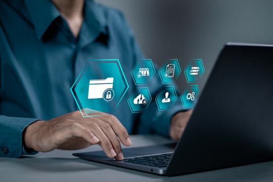 Corporate data management system concept. Personal data and corporate personal data protection. businessman using laptop with folder icon with padlock for document secure confidential access.