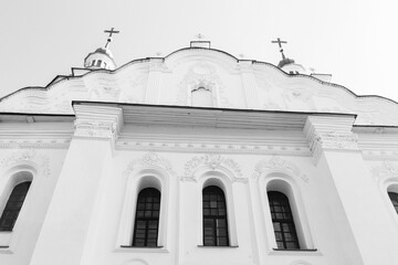 Exterior of St. Cyril church in Kyiv, Ukraine, monochrome. White stone church and crosses. Religious heritage of Ukrainian culture. Ancient christian monastery. Religious architectural heritage.  - 787334227