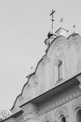 Exterior of St. Cyril church in Kyiv, Ukraine, monochrome. White stone church and crosses. Religious heritage of Ukrainian culture. Ancient christian monastery. Religious architectural heritage. Histo - 787334290