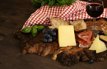 antipasti tapas with cheese and ham on wooden table
