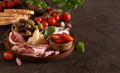 antipasti tapas with cheese and ham on wooden table