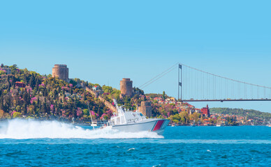 Rumeli Hisari (fortress) in to Bosphorus Sea - Coast Guard patrol boat rushing to the rescue - Istanbul, Turkey