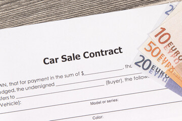 Car sale contract and euro banknotes. Sales, purchases of vehicle