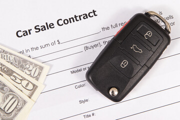 Car sale contract, car key and dollar banknotes. Sales, purchases of vehicle