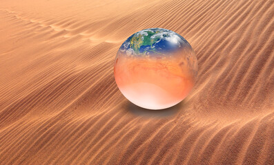 Global warming concept - Planet Earth and planet Mars on orange sand dune "Elements of this image furnished by NASA "