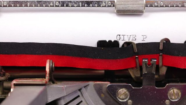 large text GIVE PEACE A CHANGE written with vintage typewriter with black ink