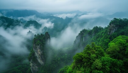 The magnificent and lush green mountain surrounded by clouds and mist, with unique rock formations above a beautiful and lush green valley