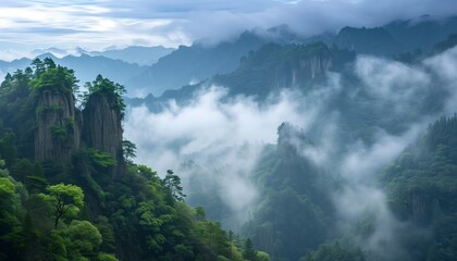 The magnificent and lush green mountain surrounded by clouds and mist, with unique rock formations above a beautiful and lush green valley