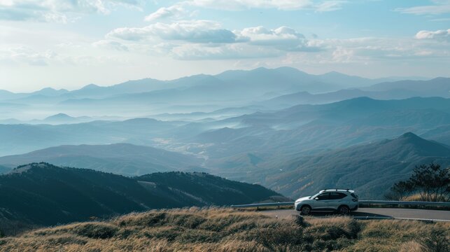 A car parked at a lookout point, with a panoramic view of mountains or a coastline. 