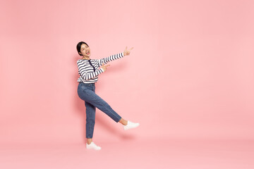 Young beautiful Asian woman pointing to empty copy space isolated on pink background - 787348008