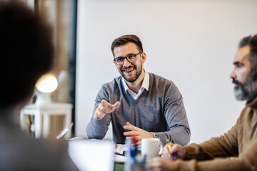 Portrait of a businessman talking on a meeting at boardroom.