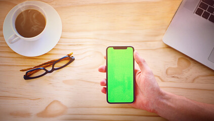 Green screen, office and above of hands with phone for advertising website, mobile app and social...