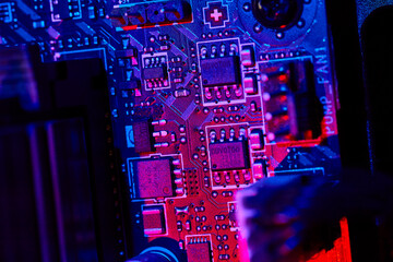 Vibrant Motherboard Circuitry Close-Up with Blue and Red Lighting