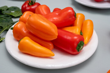 Fresh red, orange, and yellow sweet bell paprika close up