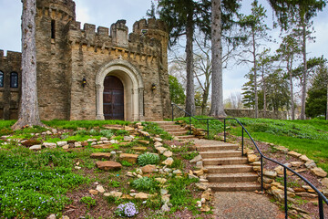 Majestic Castle Entrance with Blooming Garden Pathway
