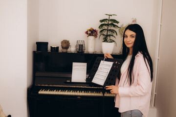 Young woman giving music lessons online at home