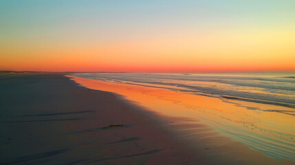 Fototapeta na wymiar Vivid sunset sky painted in orange and pink over the beach, creating a breathtaking coastal evening scene