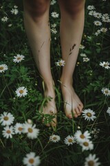 female legs standing barefoot in a field with green grass and daisies, connecting with nature in the countryside