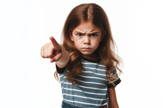 Angry kid girl pointing with finger on white background