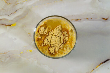 Peruvian maca in glass of water. view from above