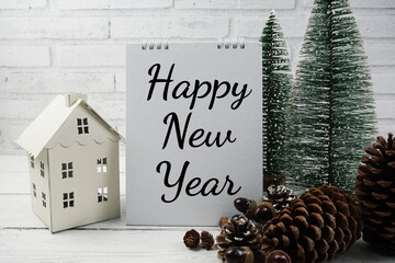 Happy New Year concept background with white house lantern and Christmas pine tree decoration on...
