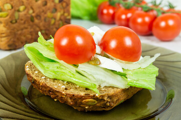 A sandwich with lettuce and tomatoes on a plate