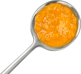 Spicy cream soup in spoon isolated on white background, top view