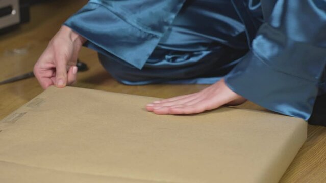 Female hands sealing a package