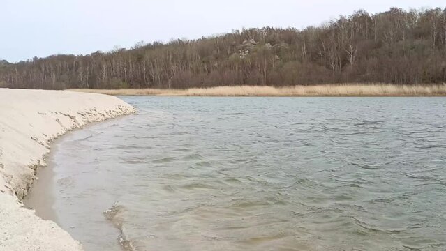 lake with small waves on the site of an amber quarry near the Baltic Sea