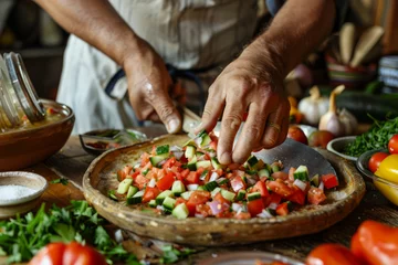 Gordijnen Hands preparing a dish with diced colorful vegetables on a rustic kitchen table, surrounded by ingredients and utensils © Emanuel