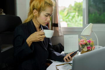 Businesswoman hand typing laptop. Person side view of Woman working online and searching business project at home office.