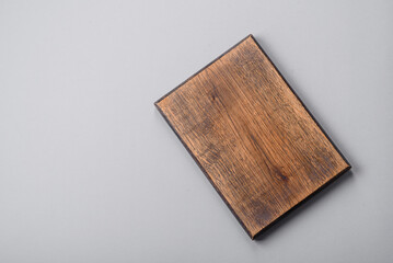 Empty wooden cutting board on gray textured concrete background